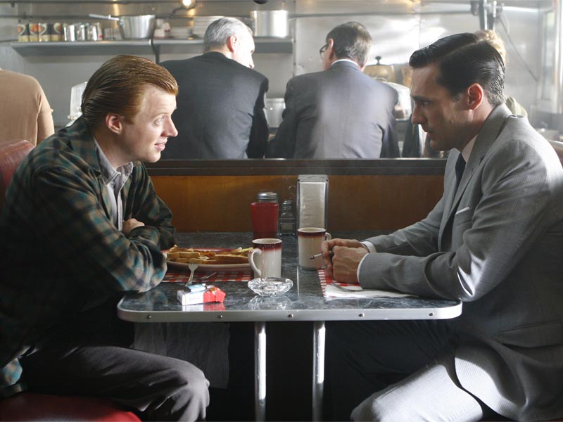 Adam Whitman (Jay Paulson) and Don Draper (Jon Hamm) - Mad Men - Season 1, Episode 5 - Photo Credit: Carin Baer/AMC