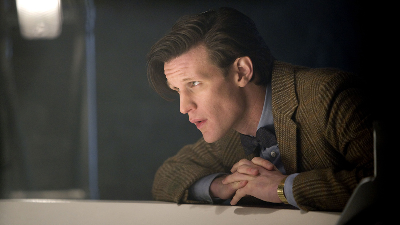 The Doctor (Matt Smith) folds his hands together.