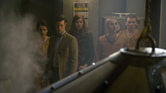 The Doctor and Amy with the factory crew