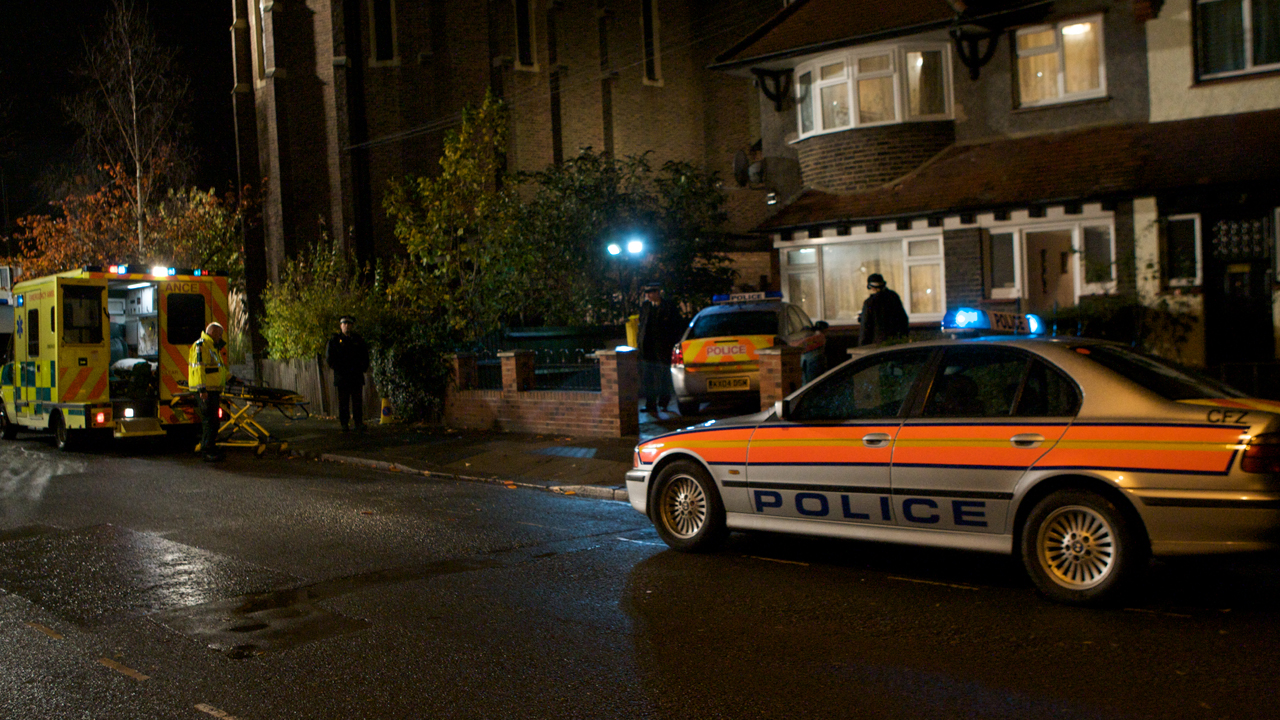 Police convene outside a crime scene