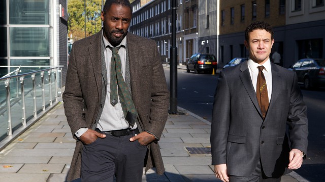 Luther walks with his partner, Justin Ripley