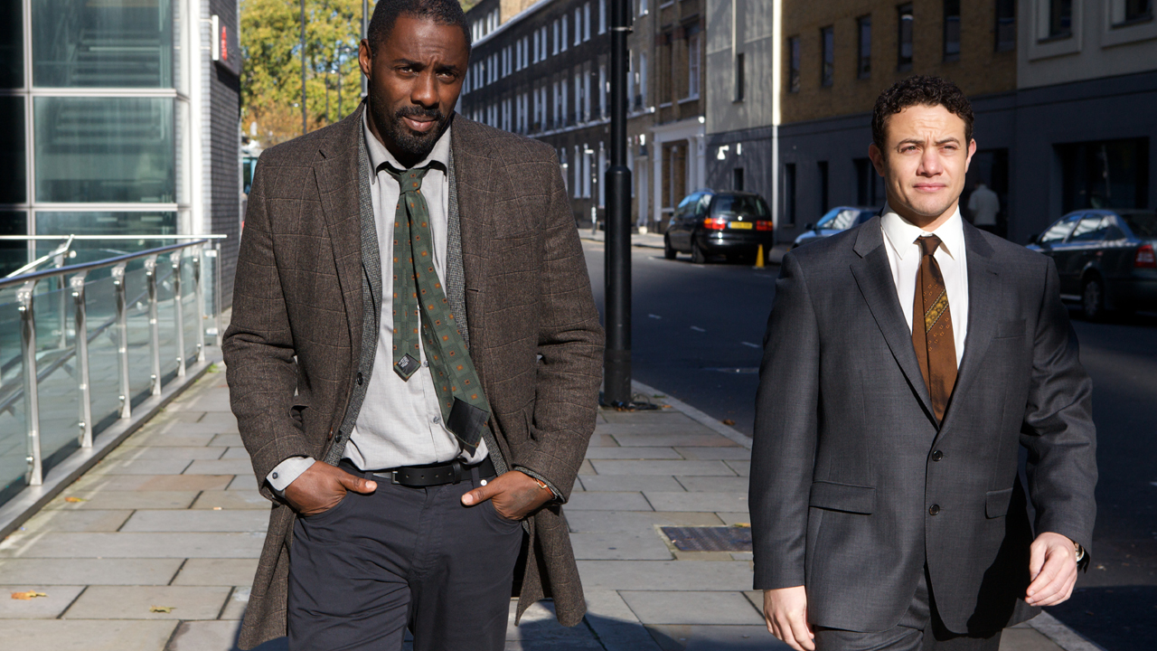 Luther walks with his partner, Justin Ripley