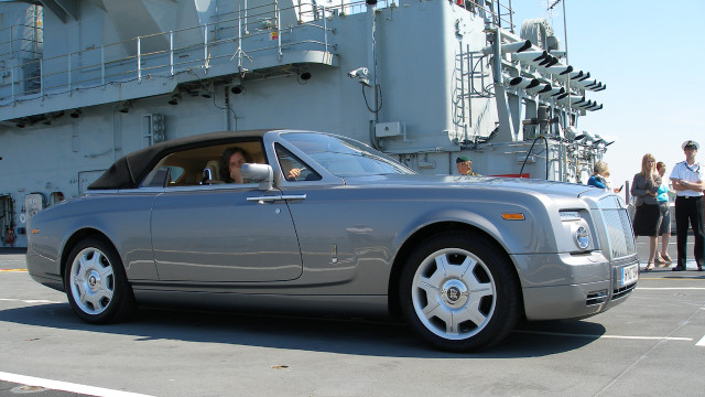 James waits in the Rolls-Royce Phantom Drophead.