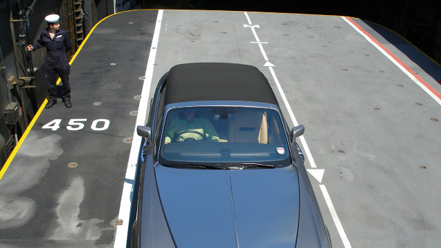 James sits in the Rolls-Royce Phantom Drophead.