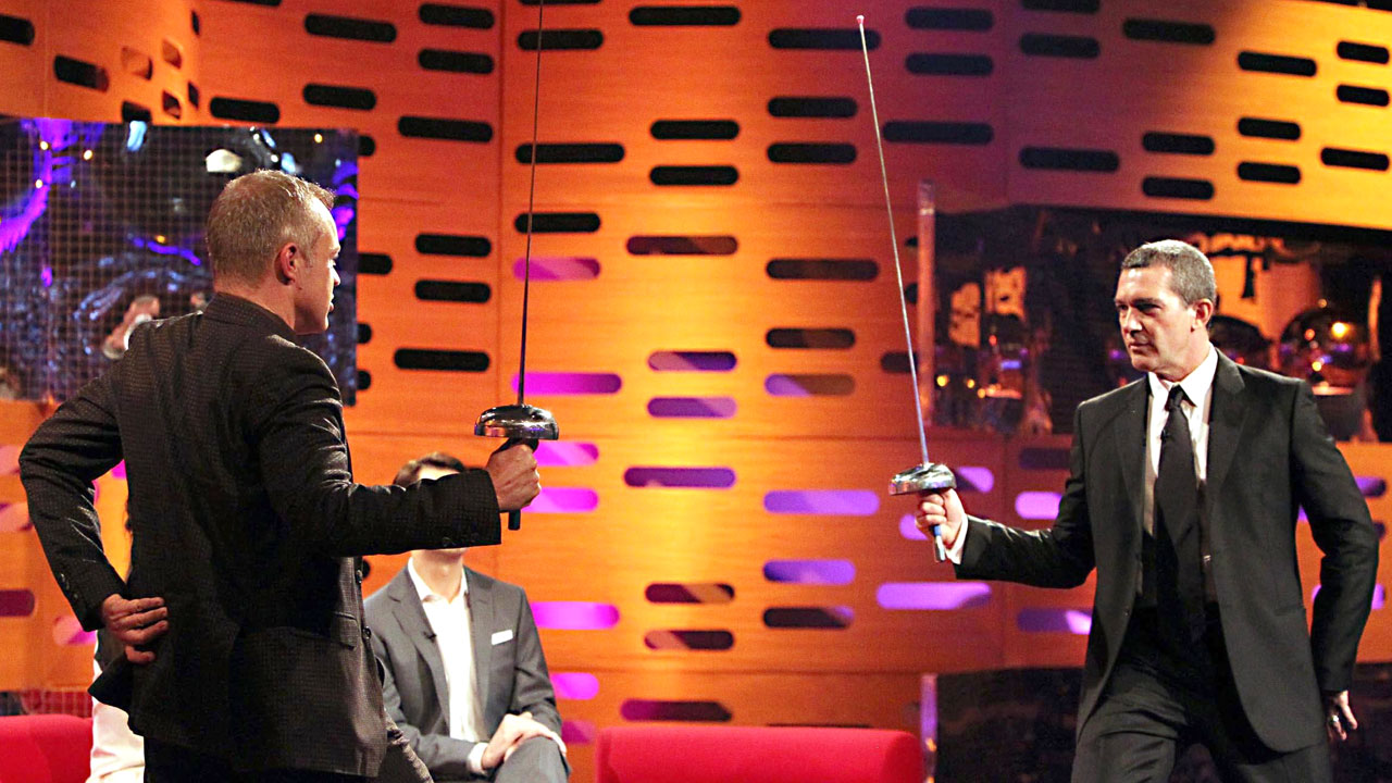 Antonio Banderas and Graham face off in an impromptu sword match.