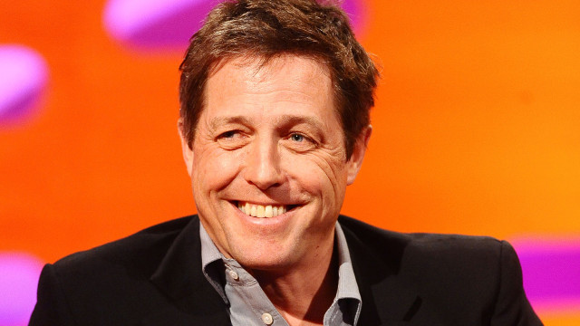 British actor Hugh Grant shows off his mega-watt smile!