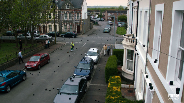 The mysterious cubes are littered on a street.