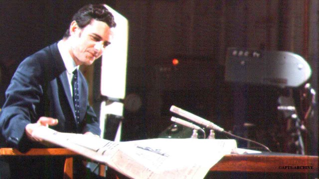 Photograph circa 1968. News reader John Edmunds (who read the news from on BBC Television from September 1968 until September 1973), sitting at the news readers desk in Studio B at Alexandra Palace. A remotely controlled television camera can be seen in the background. Four of these cameras were brought into operation at Alexandra Palace on 10th June 1961.