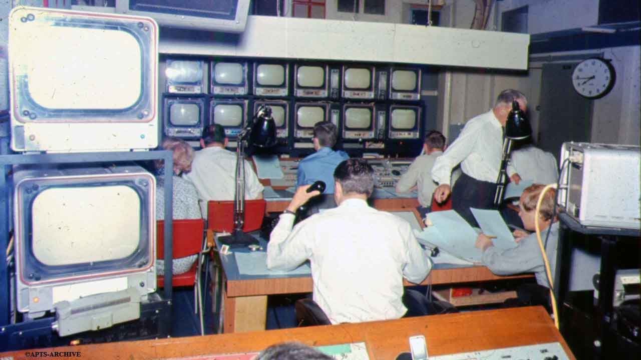 Studio B Control Gallery – opposite view of above photograph. The bank of monitor screens are clearly visible in the background, to which all those in the control room watch constantly. The control room engineer is sitting in the immediate foreground.