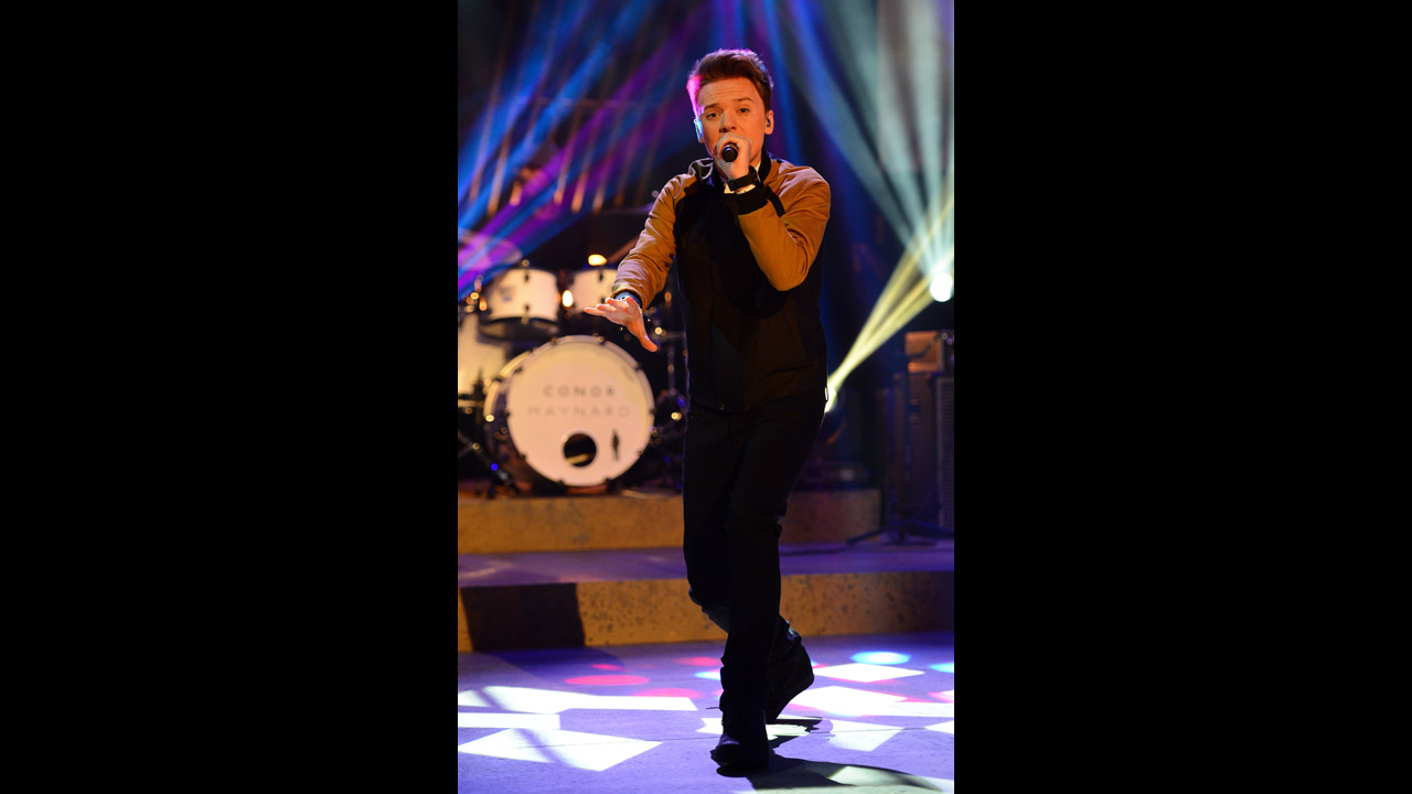 Conor Maynard sings on stage.