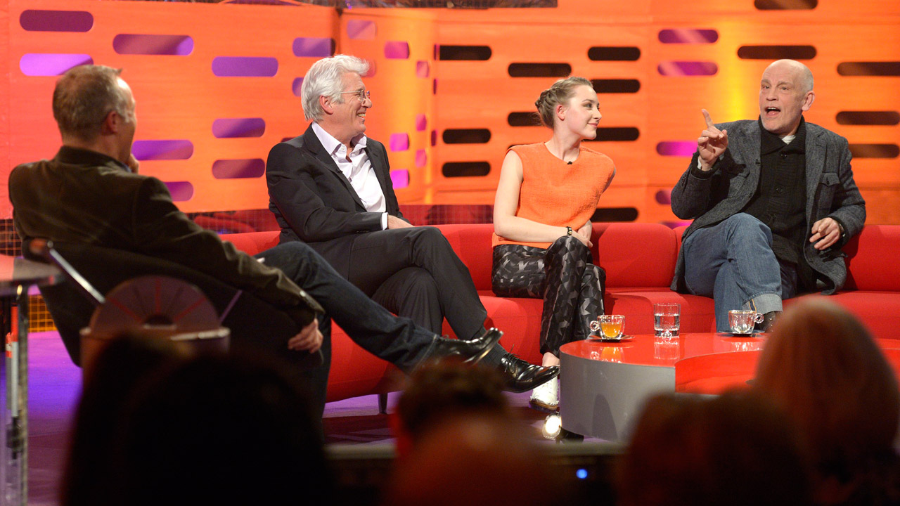 Young and old collide as Richard Gere, John Malcovich, and Saoirse Rownan crowd the couches together.