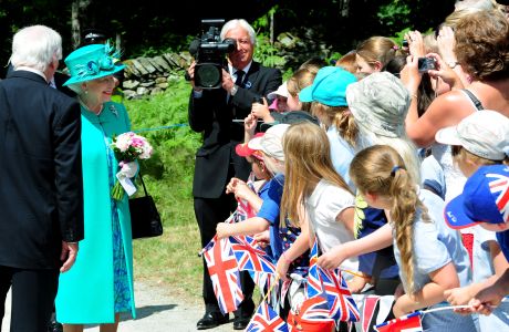 Queen Elizabeth II talks to school children from Wiggonby Church of England School as she arrives in Brockhole, Windermere, Cumbria. (Press Association via AP Images)