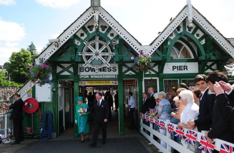 Queen Elizabeth II accompanied by Bill Bewley, Chairman of Windermere Lake Cruises arrives at Bowness on Windermere pier, Cumbria. (Press Association via AP Images)