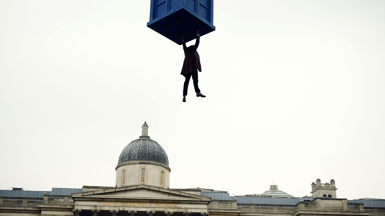 The Doctor dangles from the TARDIS. (Photo: BBC)