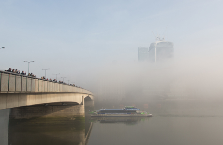 Thick fog begins to lift in morning sunlight over London Bridge on the River Thames and the 'Walkie Talkie' skyscraper Fog in London, Britain - 13 Mar 2014 (Rex Features via AP