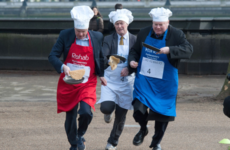 Journalist Robbie Gibb (L), David Amess MP (C) and Lord Kennedy (R) Rehab Parliamentary Pancake Race in Victoria Tower Gardens, Westminster, London, Britain - 04 Mar 2014 The charity race is organised as a competition between journalists, MPs and members of the House of Lords and proceeds are given to the charity 'Rehab'. (Rex Features via AP Images)