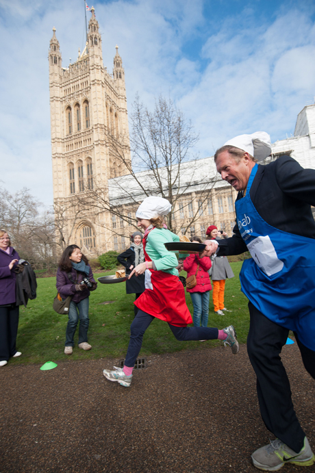 Journalist Jane Merrick (L) and Lord St John (R) Rehab Parliamentary Pancake Race in Victoria Tower Gardens, Westminster, London, Britain - 04 Mar 2014 The charity race is organised as a competition between journalists, MPs and members of the House of Lords and proceeds are given to the charity 'Rehab'. (Rex Features via AP Images)