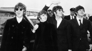 Pop group The Beatles, waving to screaming fans en route to Boston airport, America, from left to right, George Harrison, Ringo Starr, John Lennon and Paul McCartney, on August 12, 1966.