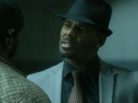 Twan shows off his new gun as he and Sylvester prep for an important meeting.