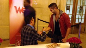 David signs an enthusiastic fan's arm.