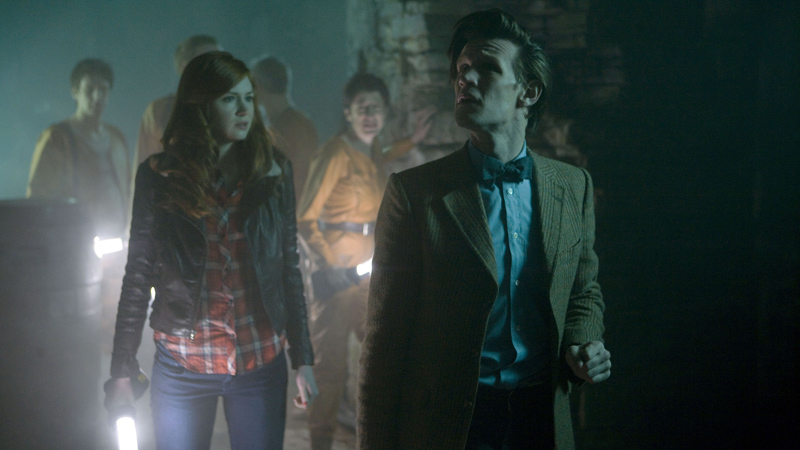 The Doctor and his companions with the factory workers