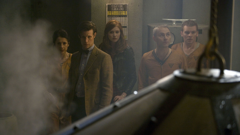 The Doctor and Amy with the factory crew