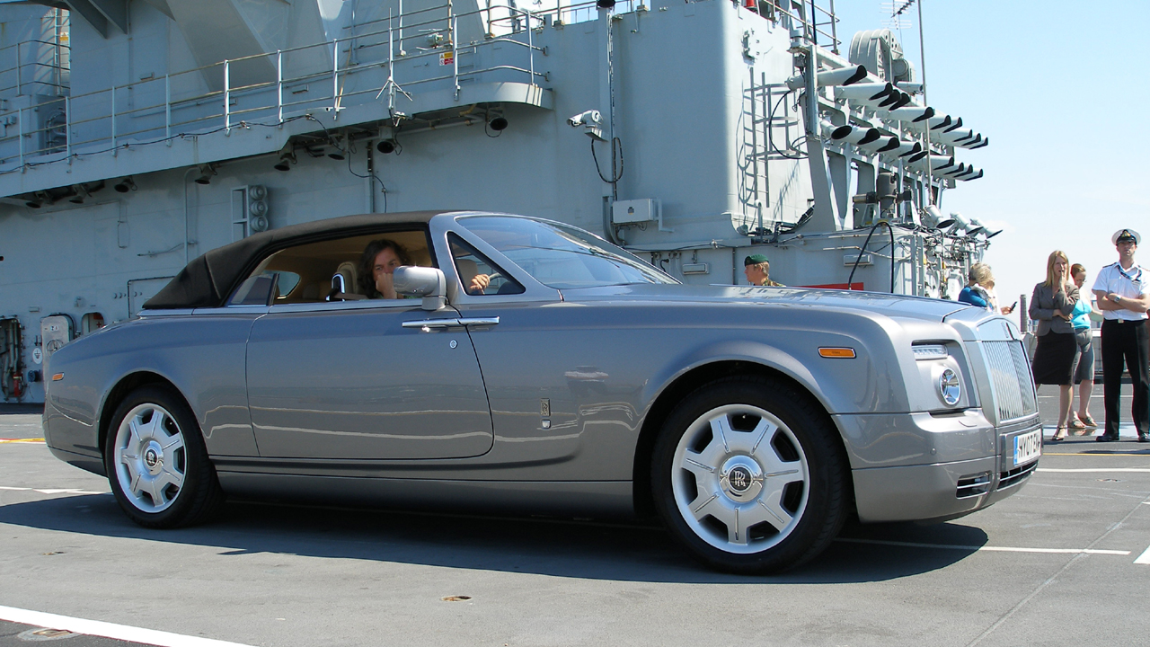 James waits in the Rolls-Royce Phantom Drophead.