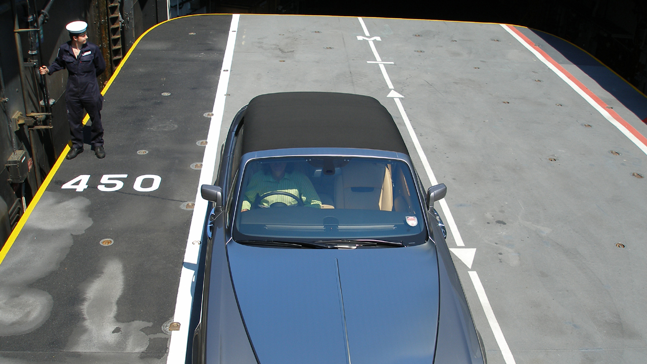 James sits in the Rolls-Royce Phantom Drophead.