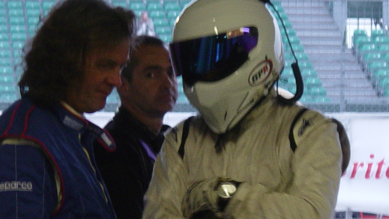 James and The Stig consult in the Top Gear pit