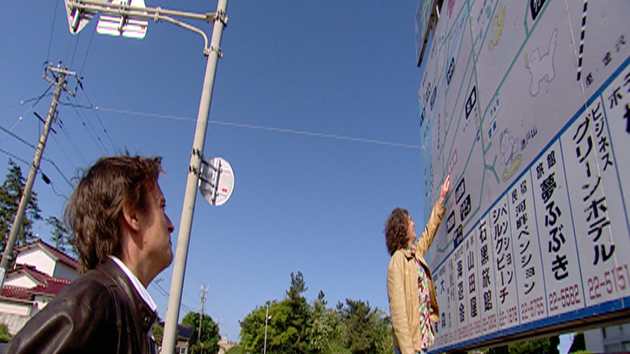 A boy and a man with interpret a Japanese map.
