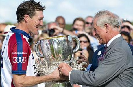 The Prince of Wales presents England captain Luke Tomlinson with the winners' trophy Audi International Polo featuring the Westchester Cup, at Guards Polo Club in Egham, Surrey. (The British Monarchy Press Association)