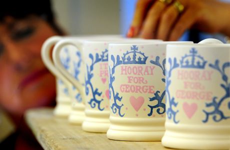 Prince George mugs go into production. Sponge decorator Lynn Lovatt puts the finishing touches to a batch of commemorative Royal Baby mugs for Prince George of Cambridge, as they go into production at the Emma Bridgewater Factory, Stoke On Trent. Picture date: Thursday July 25, 2013. The half pint mug in creal earthenware is hand decorated in the company's signature sponged technique. Its lavender blue curls and swirls frame that all important name as well as the birth date of Prince George. See PA story ROYAL Baby Pottery. Photo credit should read: Rui Vieira/PA Wire URN:17147849 (Press Association via AP Images)