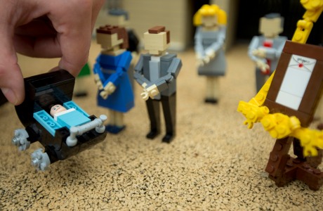 A lego figure of the Royal baby Prince George of Cambridge, in a 55-brick pram, is added by model makers along with a tiny easel in tribute to the traditional method of announcing a new Royal birth, to the 36,000 brick Buckingham Palace scene, at the Legoland Windsor Resort, Thursday, July 25, 2013. (Photo by Joel Ryan/Invision/AP)