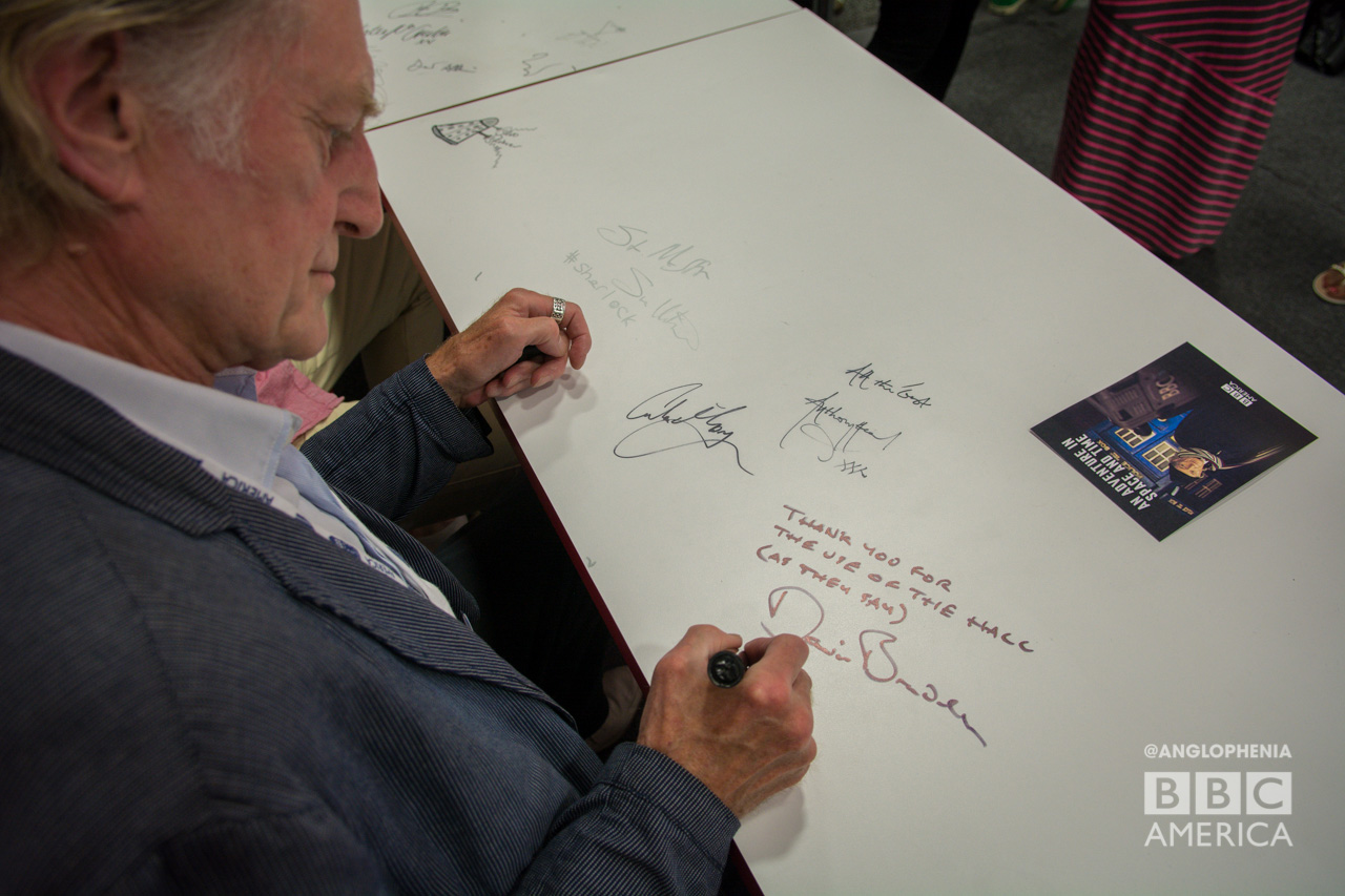 David Bradley leaves a message on the table at BBC AMERICA's booth. (Photo: Dave Gustav Anderson)