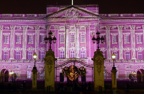 Buckingham Palace, seen illuminated by a projection at the start of New Year's Eve celebrations, in central London, before midnight, Wednesday, Dec. 31, 2003. (AP Photo/Adam Butler)