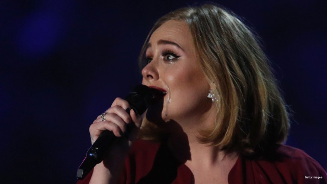 Tears run down the face of British singer Adele as she reacts after receiving the Global Success award during the BRIT Awards 2016 in London on February 24, 2016.